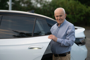 Elderly Man Standing by Car Door