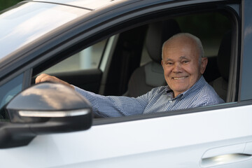 Elderly Man Smiling in Driver’s Seat of Car