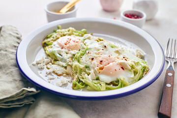 Breakfast with fried egg in zucchini noodles nest with feta cheese, healthy breakfast, close up