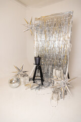 a christmas display with silver glitter and silver ornaments.