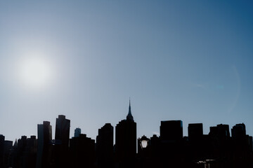 Silhouette of a City Skyline at Sunset Over the Rooftops and Nature