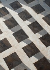 A black and white tile floor with a pattern of squares