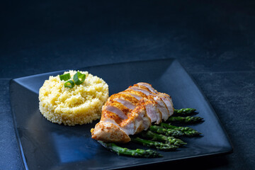 Green asparagus with grilled chicken fillet and couscous