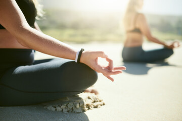 Lotus, meditation and hands of women on beach with peace, health or wellness for holistic care. Zen, relax and people at ocean for mindfulness, calm morning or outdoor yoga class in nature together