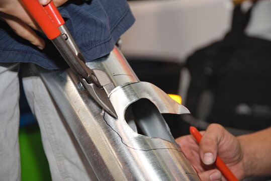Spengler schneidet mit Metallschere, Detail