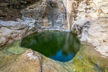 View of one of the pools of the Somogil baths in the Hondares stream in Moratalla, Region of Murcia, Spain with emerald green waters