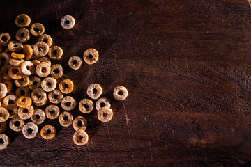Copy space with round cornflakes on a wooden surface