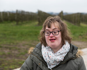 Outdoor portrait of a 37 yo woman with Down Syndrome outdoors, Tienen, Flemish Brabant, Belgium
