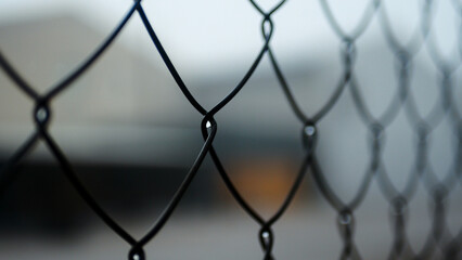 Chain-link mesh close-up, metal fencing, fog, pattern