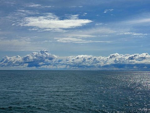Blue sea sparkling water and beautiful sky clouds 
