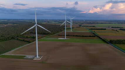 Aerial View of Large Wind Turbines Over Farmland at Dusk