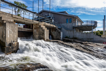 Bala Falls in Ontario showcases the blend of natural beauty and engineering with its scenic water flow and hydroelectric power station.