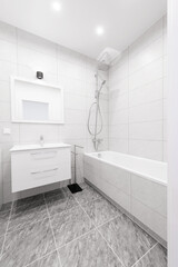 Bright Elegant Modern Luxury Home Bathroom Interior Design With White Sink. Marble Gray Walls, Mirror and Faucet. LED Lights. Shower Area, Heater, Tile Floor and Walls