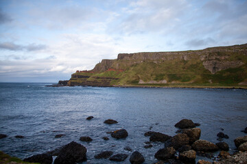 Rocky Coastline in Ireland with Green Grass and Dramatic Clouds