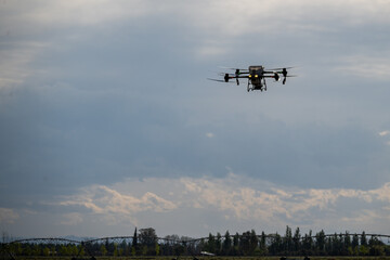 Agricultural drone in flight over a sown field.