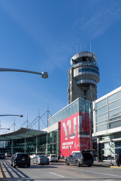 Dorval, QC, Canada - November 3, 2024: The YUL welcome sign with airport traffic control tower at Montreal-Trudeau International Airport in Dorval, QC, Canada.