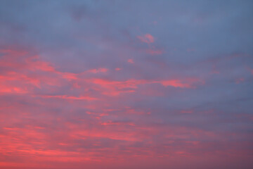 A dramatic sunrise sky filled with vibrant pink and purple clouds, creating a stunning and colorful cloudscape. 