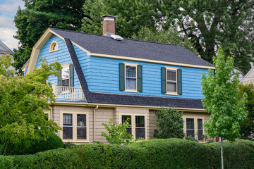 Charming two-story family home with contrasting blue and beige siding in Watertown, Massachusetts, USA