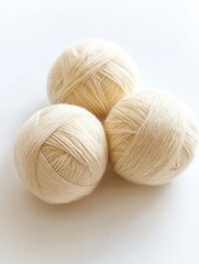 Yarn skeins. Three knitting wool balls lying on table. Beige colored threads