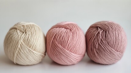 Yarn skeins. Three knitting wool balls lying on table. Beige braun pale pink colored threads 