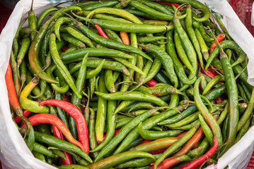 Hot peppers at a street market background.