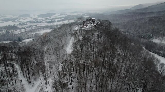 Aerial view ruins of old castle. Winter. Ruin of Hohnstein Castle, Harz mountains, Germany. High quality 4k footage