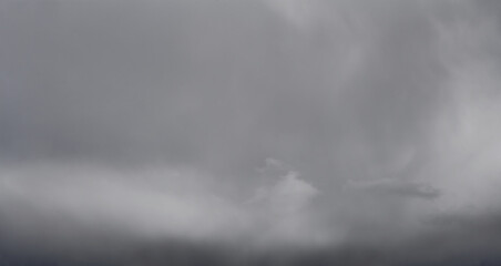 Autumn sky with dark gray clouds. Autumn sky background. Dramatic storm clouds. Dark cloudscape.