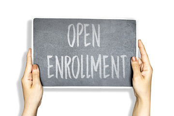 woman hands holding chalkboard with open enrollment concept