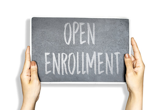 woman hands holding chalkboard with open enrollment concept
