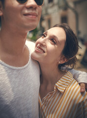 Smile, embrace and couple in city for travel holiday, relax and outdoor bonding together on romantic date. Love, man and woman hug in street with adventure, walking and happy vacation in Vietnam