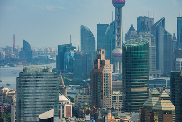 View of Shanghai's skyline featuring the Oriental Pearl Tower, modern skyscrapers, and the Huangpu...