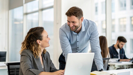 Smiling Businessman  Talking To Coworker At Laptop