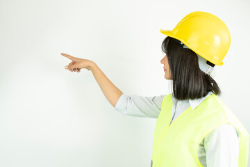 Woman architect or engineer wearing industrial helmet pointing with finger. Isolated female portrait.