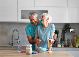 kitchen woman healthy couple morning mature bonding hug love fitness romance embracing happiness together romantic happy smiling hugging connection breakfast active