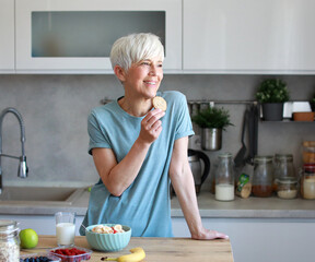 kitchen woman healthy morning mature breakfast active fitness milk cookie dessert calories eating...