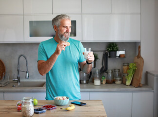 kitchen man healthy morning mature breakfast active fitness milk cookie dessert calories eating drink drinking lactose protein nutrition vitamin dairy