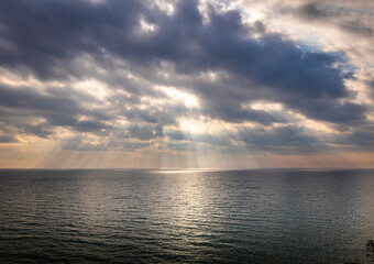 Sky replacement dramatic clouds with sun rays poking through