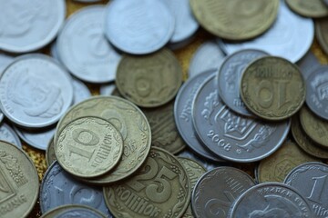 Metal coins of Ukraine of different denominations are scattered. Money texture, business background.