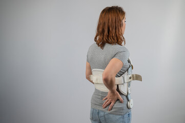 Caucasian woman in a brace after a spinal fracture. 
