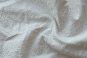 Grey textile napkin in white color as background. Folded decorative kitchen cotton towel
