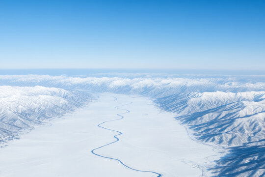 The sky is blue and the mountains are covered in snow
