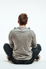 Gamer Focused in Living Room - Rear view of a man sitting cross-legged playing a video game on a console, isolated on a white background.