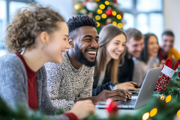 A group of people are sitting around a table with a laptop open
