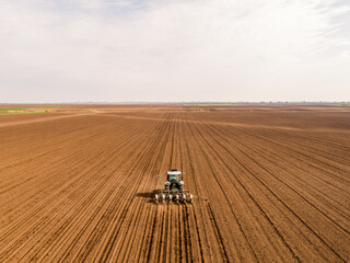 Tractor seeding in cultivated field, precision agriculture at its best