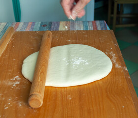 rolling dough on a wooden surface