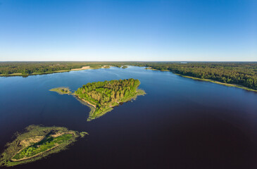 Aerial top view to island in summer evening during white nights. Vuoksa lake river and channels system leaking in Finland and Russia flowing into Ladoga. Romashki village, Leningrad region, karelia.