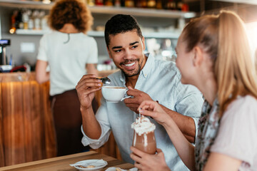 Young couple having a cup of coffee together in a cafe