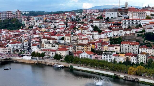 4K drone video footage of Coimbra city old town and university. Panoramic aerial cityscape of Coimbra university and Mondego River, Portugal