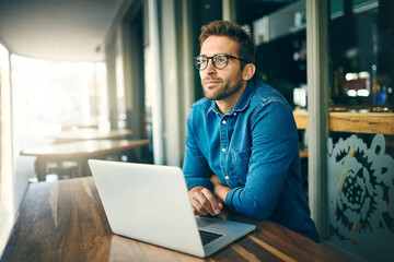 Business man, laptop and thinking at coffee shop with inspiration, happy and remote work in...