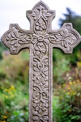 An ornate cross with intricate floral patterns etched into its design